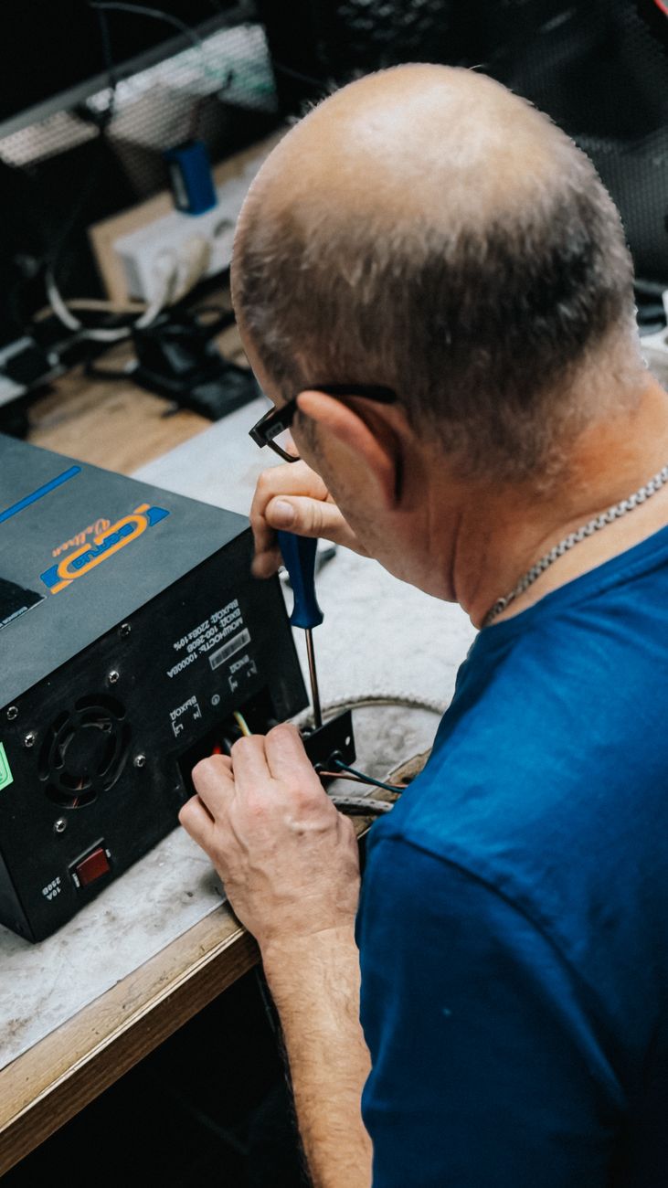 technician repairing electrical equipment in workshop